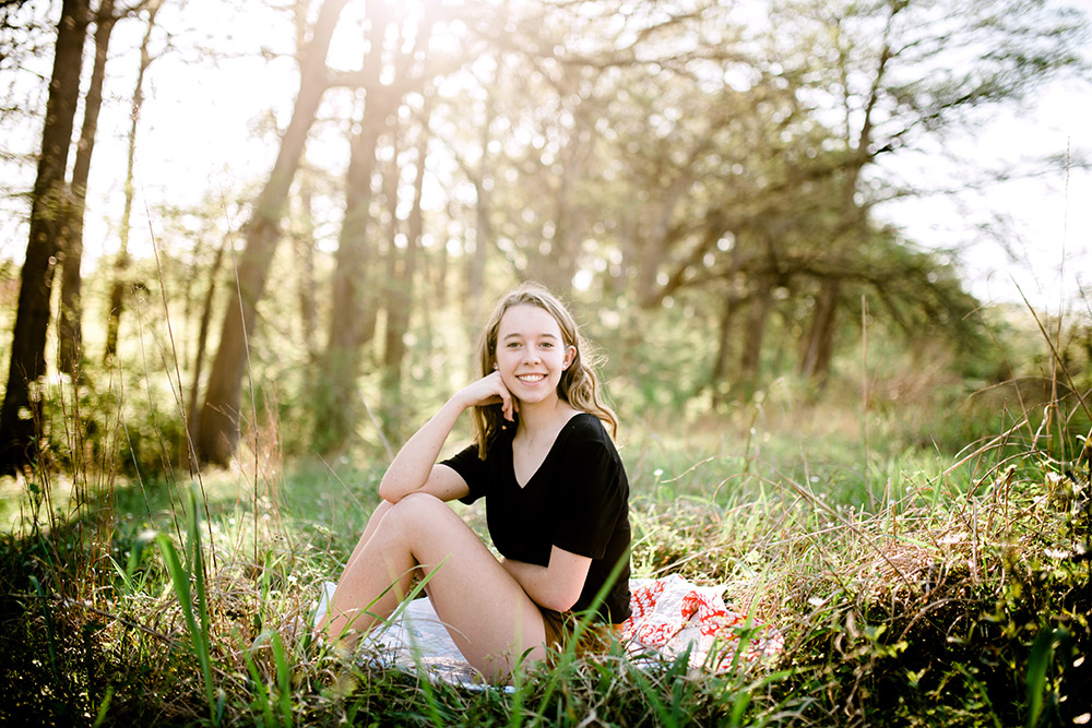 teen girl sitting on ground in san antonio texas