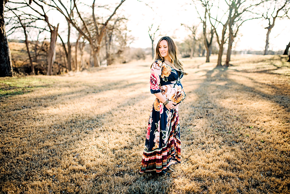 expectant mom in flower dress in texas hill country