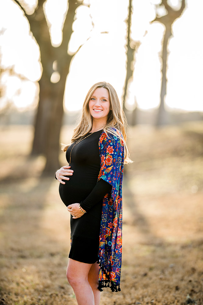 expectant mom in black dress in texas hill country