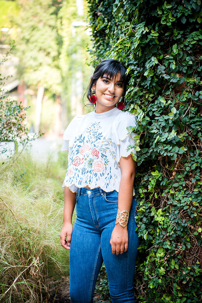 teen girl standing against greenery in san antonio texas