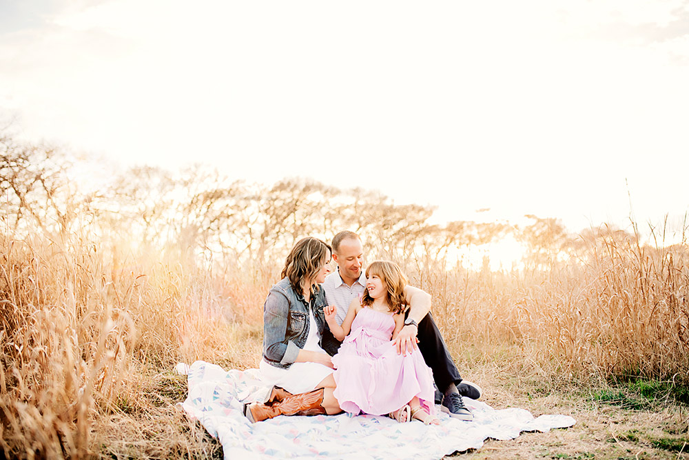 family sitting on ground in texas hill country