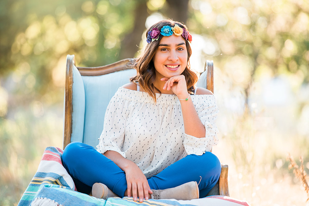 teen girl sitting in chair in texas hill country