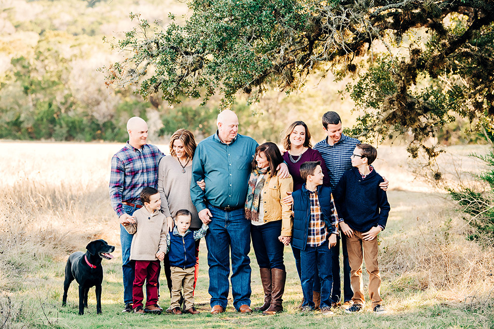 family standing in field in texas hill country