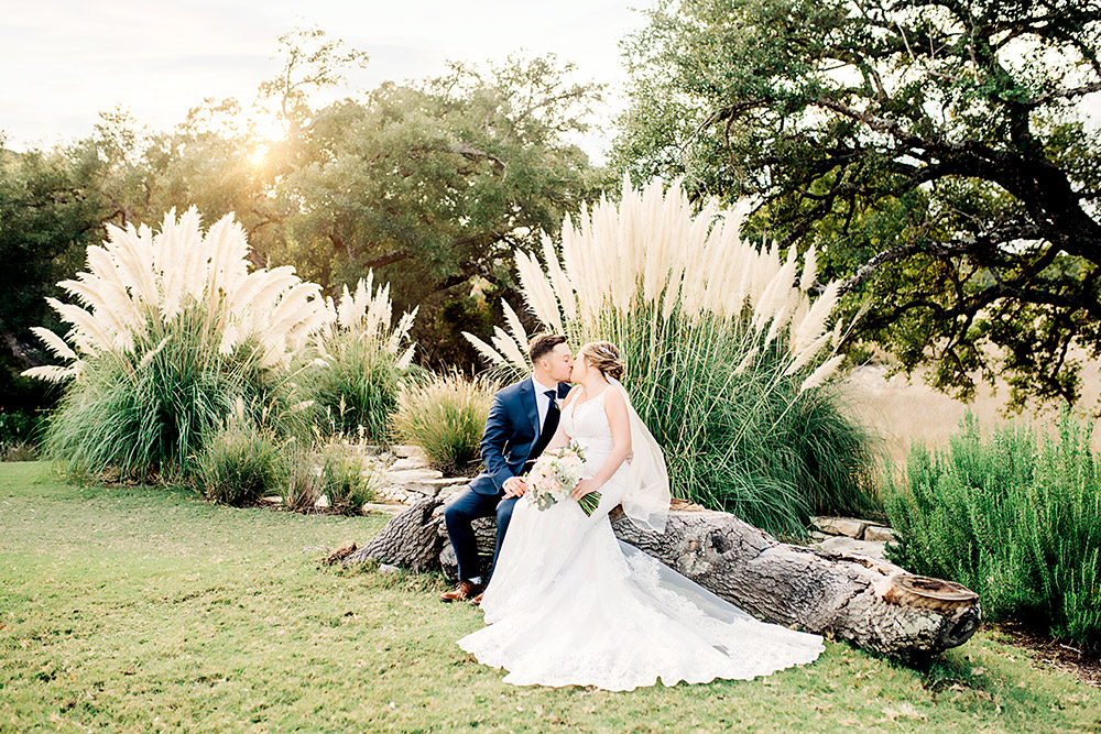 bride and groom kissing in texas hill country