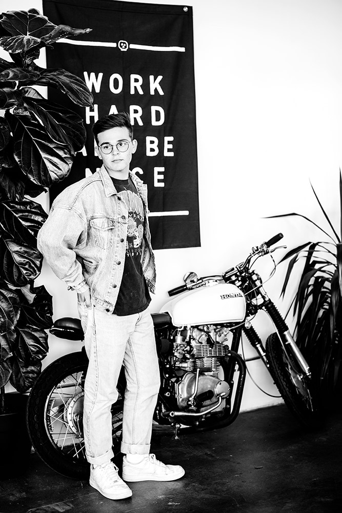 teen boy standing by motorcycle in san antonio texas