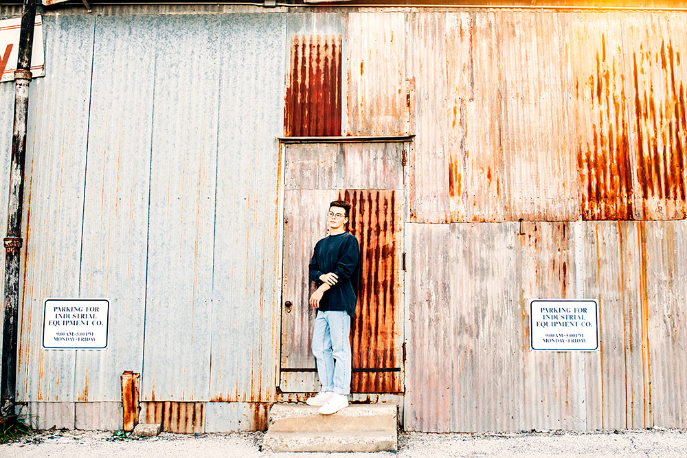 teen boy standing against a wall in san antonio texas